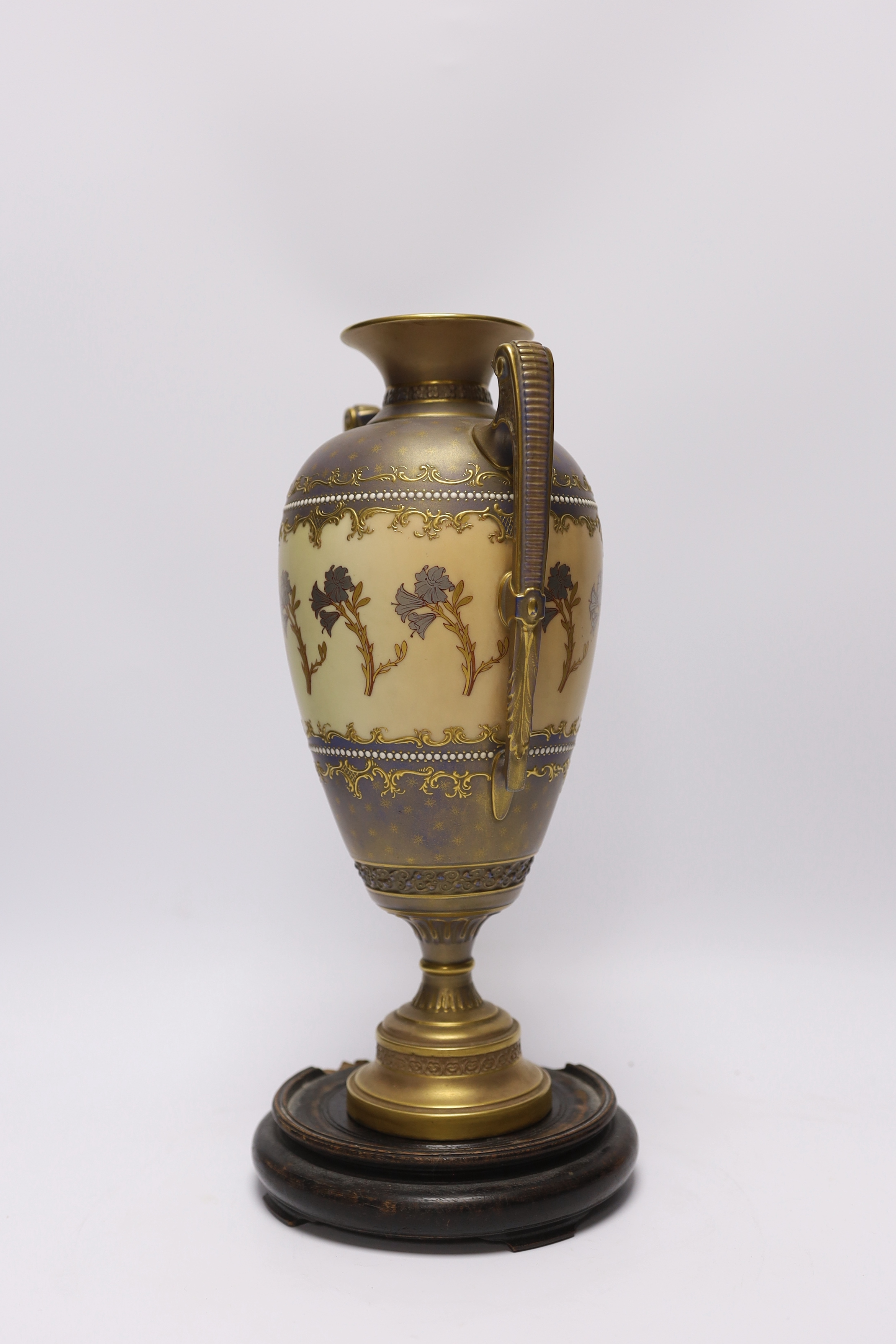 A Royal Worcester blush ivory two handled vase, model no. 1481, with hardwood stand, 31cm